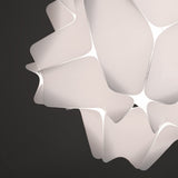 A white matte pendant lamp shade with a geometric design, featuring precisely cut rectangles and softly rounded corners in detail