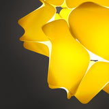 A glossy yellow pendant lamp shade with a geometric design, featuring precisely cut rectangles and softly rounded corners in detail
