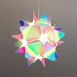 Ceiling view of a pink and blue iridescent spherical lampshade with the light off.