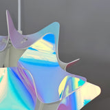 Close-up view of a pink and blue iridescent spherical lampshade with bright light on, showing star- or petal-like patterns.
