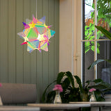 Pink and blue iridescent spherical lampshade hanging from a ceiling, with a visible colorful pattern resembling stars or petals.